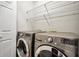 Laundry room with new stainless steel washer and dryer, wire rack shelving, and storage at 5600 Walnut Creek Nw Ct, Lilburn, GA 30047