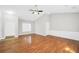 Bright living room featuring a tall ceiling, and hardwood flooring, creating a modern living space at 5600 Walnut Creek Nw Ct, Lilburn, GA 30047