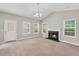Cozy living room featuring a fireplace, neutral carpet, and bright windows at 5600 Walnut Creek Nw Ct, Lilburn, GA 30047