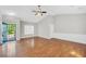 Spacious living room with vaulted ceilings, hardwood floors, and a modern ceiling fan at 5600 Walnut Creek Nw Ct, Lilburn, GA 30047