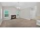 Bright living room boasts a fireplace, neutral paint, and large windows for natural light at 5600 Walnut Creek Nw Ct, Lilburn, GA 30047