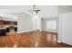 Open-concept living space with hardwood floors, and view into the kitchen at 5600 Walnut Creek Nw Ct, Lilburn, GA 30047