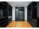 Spacious walk-in closet featuring custom shelving, drawers, and ample hanging space at 5600 Walnut Creek Nw Ct, Lilburn, GA 30047