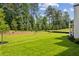 A lush green backyard with manicured lawn offers a serene outdoor space, great for relaxing or entertaining at 225 River Valley Ct, Atlanta, GA 30328