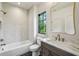 Bright bathroom features a shower/tub, gray vanity with marble countertop and brass faucet at 225 River Valley Ct, Atlanta, GA 30328