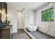 This luxurious bathroom features a soaking tub, glass shower, dual vanities, and marble accents at 225 River Valley Ct, Atlanta, GA 30328