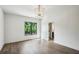 Bright bedroom with large window, hardwood floors, recessed lights, and chandelier at 225 River Valley Ct, Atlanta, GA 30328