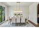 Charming dining room with elegant chandelier, table and chairs, and a large window at 225 River Valley Ct, Atlanta, GA 30328