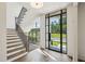 Open entryway with wood stairs, iron railing, large picture windows, and great natural light at 225 River Valley Ct, Atlanta, GA 30328