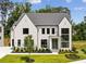 Stunning two-story home featuring a modern design, manicured lawn, and beautiful landscaping at 225 River Valley Ct, Atlanta, GA 30328