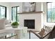Close-up of the fireplace with modern mantel, herringbone brick, and comfortable seating area at 225 River Valley Ct, Atlanta, GA 30328