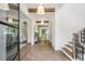Welcoming foyer featuring hardwood floors, elegant lighting, and a staircase with black accents at 225 River Valley Ct, Atlanta, GA 30328