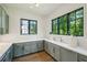 Stylish kitchenette featuring gray cabinetry, marble countertop, and natural light from the windows at 225 River Valley Ct, Atlanta, GA 30328
