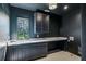Laundry room with a window above the sink and ample storage space in the cabinetry and marble countertops at 225 River Valley Ct, Atlanta, GA 30328