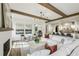 Open-concept living room flows into a modern kitchen, featuring wood beams and comfortable seating at 225 River Valley Ct, Atlanta, GA 30328