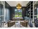 Modern home office featuring dark walls, built-in shelving, and stylish decor at 225 River Valley Ct, Atlanta, GA 30328