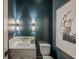 Contemporary powder room featuring marble countertop, modern lighting, and elegant decor at 225 River Valley Ct, Atlanta, GA 30328