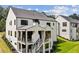 Stunning rear exterior showcasing a multi-level deck and stairs leading to a manicured lawn at 225 River Valley Ct, Atlanta, GA 30328