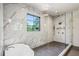 Beautiful, modern shower and bathtub with glass door, marble tile and brass fixtures at 225 River Valley Ct, Atlanta, GA 30328