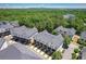 Aerial shot of townhomes surrounded by lush greenery with the city skyline in the distance at 3693 Allegretto Cir, Atlanta, GA 30339