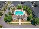 Aerial view of a community pool and amenity center surrounded by lush greenery and townhomes at 3693 Allegretto Cir, Atlanta, GA 30339
