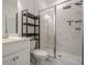 Modern bathroom featuring glass shower doors and sleek shelving for storage at 3693 Allegretto Cir, Atlanta, GA 30339