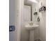 Compact half-bath with pedestal sink and decorative wall accents at 3693 Allegretto Cir, Atlanta, GA 30339