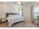 Well-lit bedroom with a plush bed and window with neutral-toned curtains at 3693 Allegretto Cir, Atlanta, GA 30339