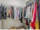 Walk-in closet with organized hanging clothes and shelving for shoes at 3693 Allegretto Cir, Atlanta, GA 30339