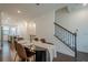 Open-concept dining area with stylish chairs and stairway to the second floor at 3693 Allegretto Cir, Atlanta, GA 30339