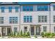 Charming townhome exterior with light brick, neutral siding, and professional landscaping at 3693 Allegretto Cir, Atlanta, GA 30339
