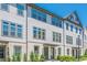 Charming townhome exterior with a mix of white siding and brick accents, plus manicured landscaping at 3693 Allegretto Cir, Atlanta, GA 30339