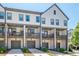 A row of modern townhomes, each featuring a garage and a private balcony or patio at 3693 Allegretto Cir, Atlanta, GA 30339