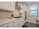 Gourmet kitchen showcasing white cabinetry, stainless appliances and light tile backsplash at 3693 Allegretto Cir, Atlanta, GA 30339