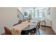 Open-concept dining and living area with hardwood floors, a ceiling fan, and lots of natural light at 3693 Allegretto Cir, Atlanta, GA 30339