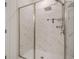 Modern shower with marble tiling, glass doors, and sleek fixtures at 3693 Allegretto Cir, Atlanta, GA 30339