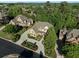 Aerial view of a large home with a circular driveway, lush landscaping, and mature trees at 8805 Marion Dr, Duluth, GA 30097