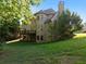 Spacious backyard with a well-maintained lawn and a multi-story brick house at 8805 Marion Dr, Duluth, GA 30097