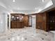 Basement with a wet bar, pendant lighting, tile floors, and paneled walls at 8805 Marion Dr, Duluth, GA 30097