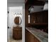 Bathroom with wood vanity, elegant lighting, and a decorative mirror detail at 8805 Marion Dr, Duluth, GA 30097