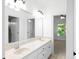 Bathroom features a double sink vanity, large mirror, and adjacent doorway to a bedroom at 8805 Marion Dr, Duluth, GA 30097