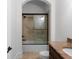 This bathroom features a shower with a sliding glass door, light beige tile, and granite counters at 8805 Marion Dr, Duluth, GA 30097