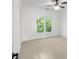 Bedroom features neutral walls, carpet, and large window for ample natural light at 8805 Marion Dr, Duluth, GA 30097