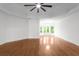 Spacious bedroom featuring hardwood floors, tray ceiling, and a wall of windows offering ample natural light at 8805 Marion Dr, Duluth, GA 30097