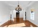 Formal dining room with hardwood floors, decorative columns, and a stylish chandelier at 8805 Marion Dr, Duluth, GA 30097