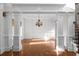 Elegant dining room with hardwood floors, decorative columns, and a classic chandelier at 8805 Marion Dr, Duluth, GA 30097