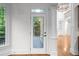 Door leading to wooden deck with column trim, wooden floors, and views of lush greenery at 8805 Marion Dr, Duluth, GA 30097
