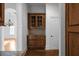 Hallway with hardwood floors, a built in cabinet, and access to another room, flooded with natural light at 8805 Marion Dr, Duluth, GA 30097