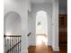 Arched hallway with decorative columns and views to the kitchen at 8805 Marion Dr, Duluth, GA 30097