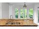 Bright kitchen featuring granite countertops, a stainless steel faucet, and a scenic view from the window at 8805 Marion Dr, Duluth, GA 30097